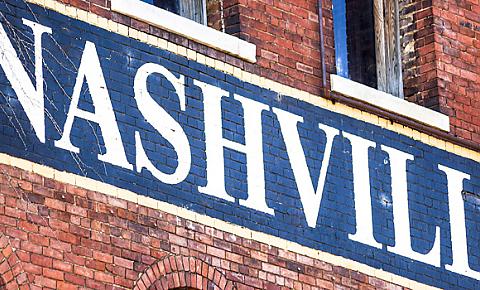 Photo of Nashville sign painted on a brick wall