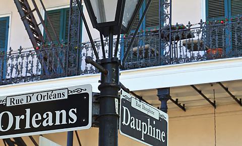 Photo of New Orleans sign post and balcony